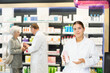 © JackF - Kind young apothecary holding a box with remedy standing against shelves full of medicine in drugstore chemistry