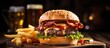 bacon cheeseburger on toasted pretzel bun served with fries and beer shot with selective focus. Copy space image. Place for adding text or design