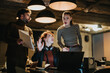 © qunica.com - Confident business people discussing a new project in a creative office. Working extra hours to meet a deadline, they analyze market data and plan business expansion.