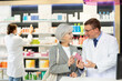 © JackF - Interested old lady asking middle-aged male apothecary for advice concerning preparation in box in drugstore