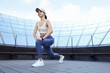 Beautiful woman in stylish sportswear doing exercises outdoors. Space for text