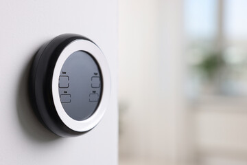 one thermostat on white wall indoors, space for text. smart home system