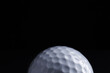 © New Africa - Golf ball on black background, closeup. Space for text