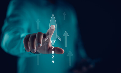 Poster - Businessman Pointing rocket icon with Happy New year 2024, countdown merry Christmas and happy new year, Planning and challenge strategy business in new year 2024 Concept. New business start up 2024