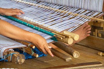 A craftsman is making cloth from thread in the Baduy area