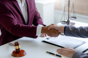 Wall Mural - Businessman handshake to seal a deal with his partner lawyers or attorneys discussing a contract agreement.