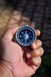 © Dani - Hand holding a compass with blur background
