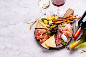 Wall Mural - Antipasto board with various meat and cheese snacks