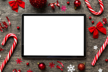 Wall Mural - Top view of empty tablet on Christmas background made of new year decorand festive decorations. New year holiday concept. Mockup