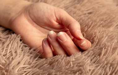 Sticker - A woman's hand on a beige carpet with lint