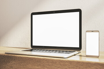 Canvas Print - Close up of clean white laptop and smartphone on wooden desk. Concrete wall background. Device presentation and online education concept. Mock up, 3D Rendering.