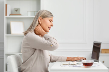 Poster - Woman suffering from neck pain at workplace in room