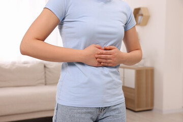 Sticker - Woman suffering from abdominal pain at home, closeup. Unhealthy stomach