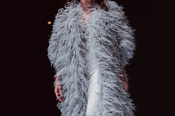 Sticker - Haute couture gray ostrich feather coat. Fashion details on black background