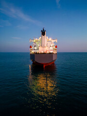 A massive cargo ship wood chips carrier in the sea, aerial view