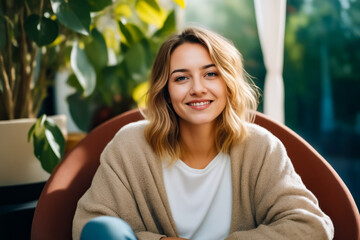 Sticker - Woman sitting in chair smiling at the camera.