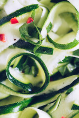 Wall Mural - Healthy salad with fresh zucchini, mint and hot chilli pepper on a white plate