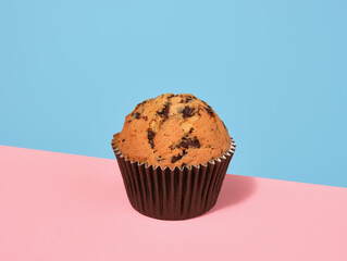 Wall Mural - Fresh baked muffin with chocolate chunks. Delicious dessert and sweet delight.