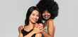 Beauty asian woman posing with her friend with afro hairstyle. Cheerful, elegant girls standing together,