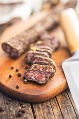 Wall Mural - Smoked dried sausage. Sliced sausage on cutting board.