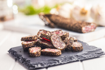 Wall Mural - Smoked dried sausage. Sliced sausage on cutting board.