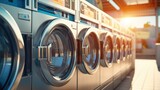 Fototapeta  - Multiple Industrial washing machines in laundry shop, washing with hot and cold water keeps clothes clean and trendy. A row of industrial washing machines in a public laundromat