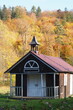 Mały drewniany kościółek w jesiennym lesie