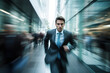 © FutureStock - Handsome businessman rushing on the city street with blurred people in the background.