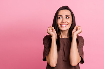 Sticker - Photo of delighted positive person toothy smile raise fists triumph look empty space isolated on pink color background