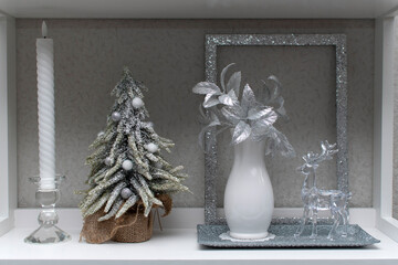 Wall Mural - Still life with a candle, christmas tree, vase with flowers and glass deer	