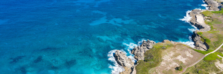 Wall Mural - Macao beach with turquoise water and stone cliff. Dominican Republic. Aerial view from drone . Long banner