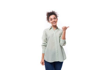 positive smiling young woman with curly messy hairstyle dressed in a shirt