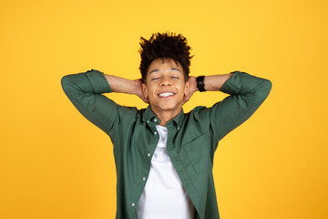 Wall Mural - Well-rested young black guy posing with arms behind head