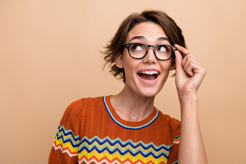 Sticker - Photo of astonished pretty lady arm touch glasses look empty space ad isolated on beige color background