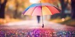 Experience the weather concept with rain falling on a rainbow umbrella, capturing both spring and fall showers, accompanied by abstract defocused drops and subtle light flare effects