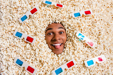 Canvas Print - Top view photo of playful carefree guy nerd about watching new film full in pop corn background isolated