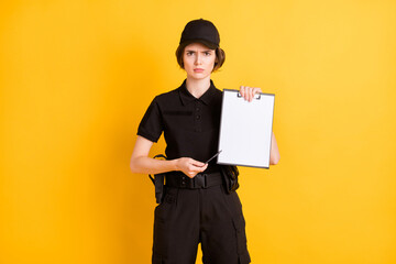 Sticker - Photo of serious young girl hand hold point pen empty space clip board you isolated on yellow color background