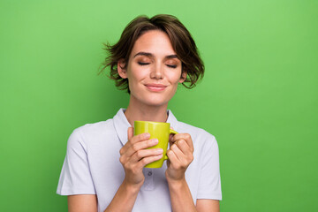 Sticker - Photo of cute pretty lovely girl wear stylish clothes hold tasty cappuccino enjoying rest isolated on green color background