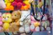 © aapsky - Toy crane vending machine, claw game or cabinet to catch the toys. Shopping, holiday activity, game of chance. Selective focus on crane.