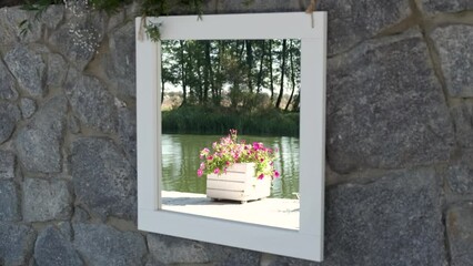 Wall Mural - Mirror painting on a stone wall with reflection of a decorative flower vase on a wharf near the river.