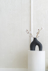 Poster - Elevate your home with a touch of elegance and simplicity a blank wall, a vase of flowers, and a cozy living space await your personal style.