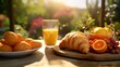 Breakfast with orange juice and croissants on table in garden