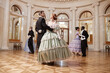 © Seventyfour - Full length view at couples dancing in palace ballroom and swirling on parquet floor