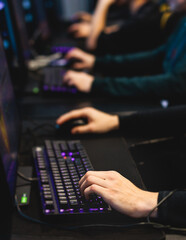 Cyber sport e-sports tournament, team of professional gamers, hands on a mouse and keyboard, players playing online championship in competitive moba, strategy fps game in a cyber games arena club