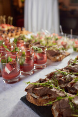 Wall Mural - light snacks for the holiday, catering. Various light snacks. Catering plate. Assortment of sandwiches on the buffet table. meat, fish, vegetable canapes.