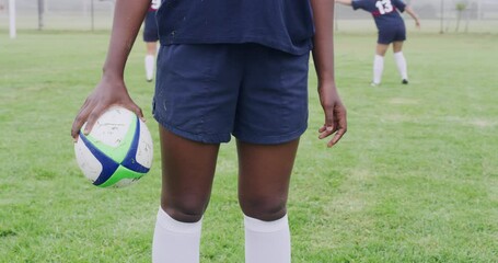 Poster - Person, hand and rugby ball on field for sports, fitness and training for competition outdoor with closeup. Athlete, team and people on pitch for contest, games and workout together for tournament