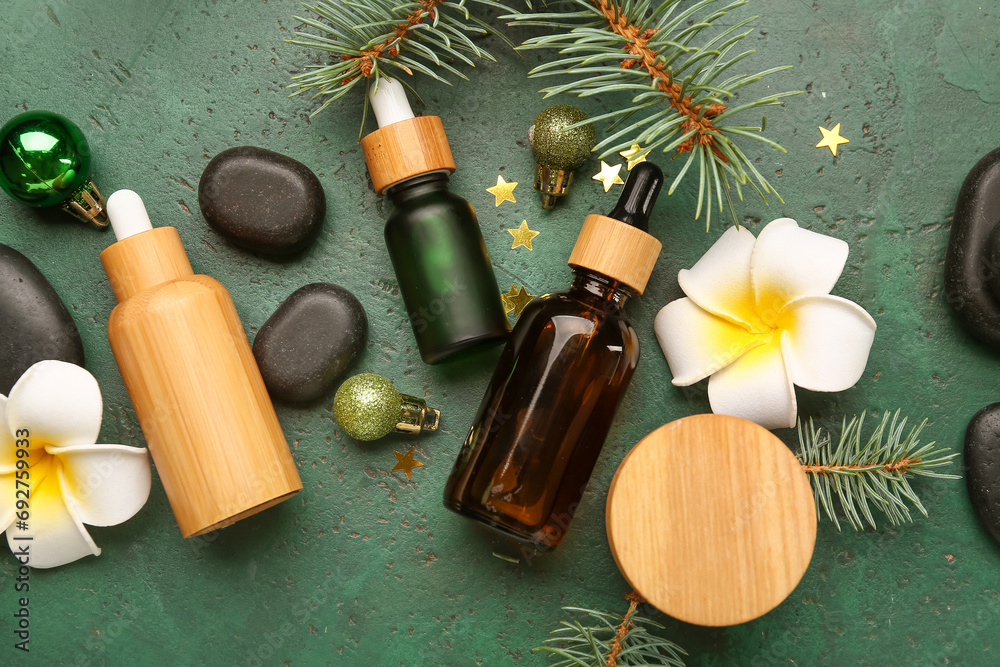 Beautiful spa composition with tropical flowers and Christmas decorations on green background