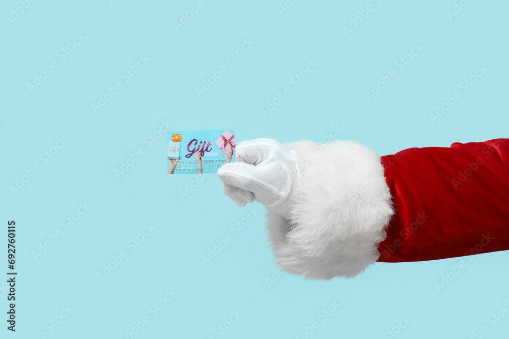 Santa Claus with gift card on blue background