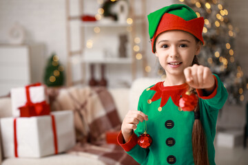 Sticker - Cute little girl in elf costume with Christmas balls at home