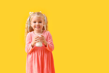 Sticker - Cute little girl with glass of milk on yellow background